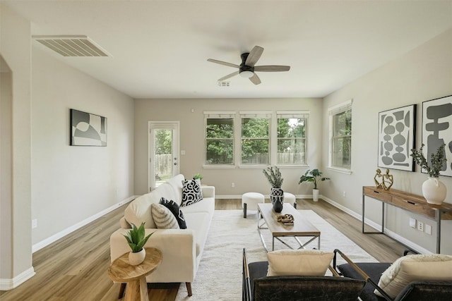 living room with ceiling fan and light hardwood / wood-style flooring