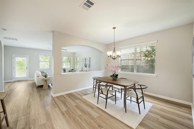 dining room with a notable chandelier and light hardwood / wood-style flooring