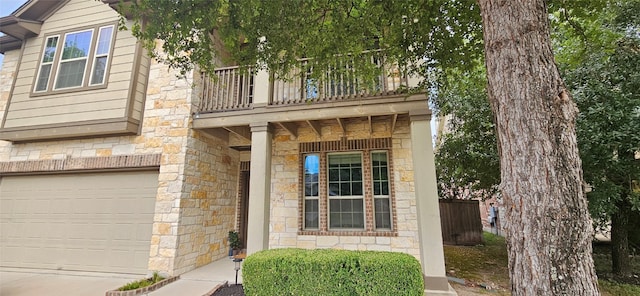 exterior space with a balcony and a garage