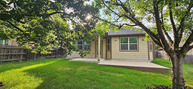 back of house with a yard and a patio area