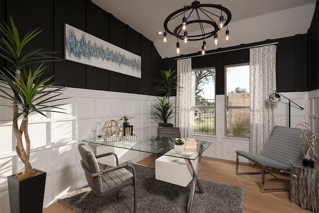 dining area with vaulted ceiling, a notable chandelier, and light wood-type flooring