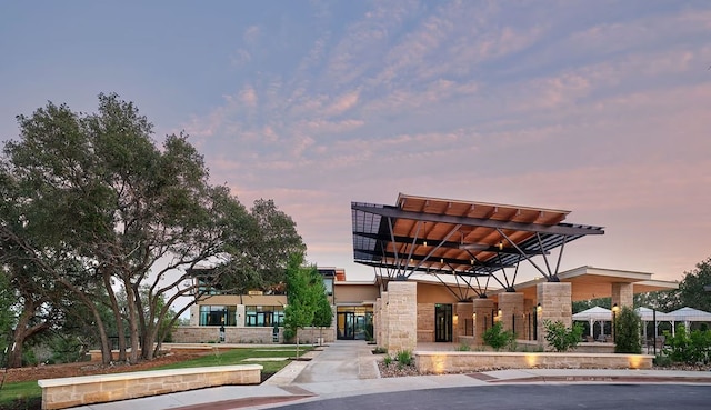 view of outdoor building at dusk