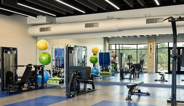 exercise room with a towering ceiling