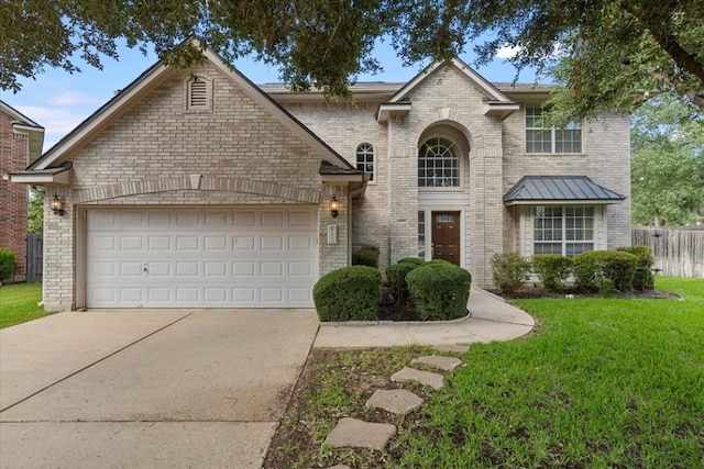 view of front of property with a garage and a front lawn