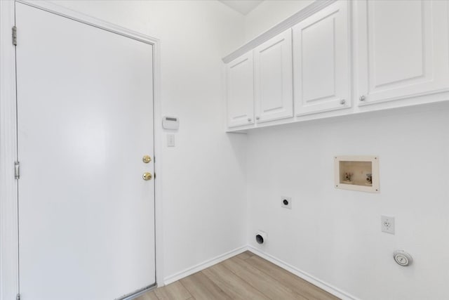 laundry room featuring light hardwood / wood-style flooring, electric dryer hookup, cabinets, and washer hookup