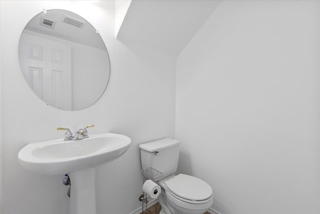 bathroom featuring toilet and vaulted ceiling