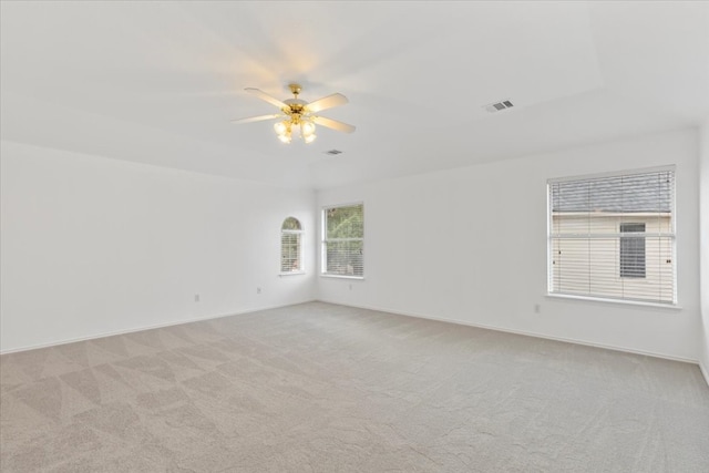 unfurnished room featuring light carpet and ceiling fan