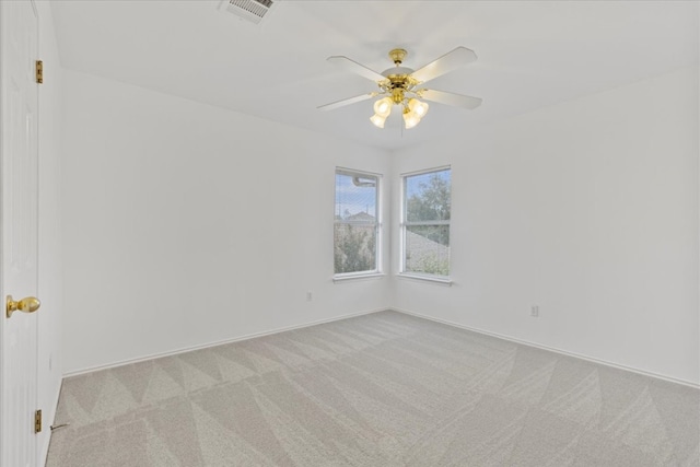 carpeted spare room with ceiling fan