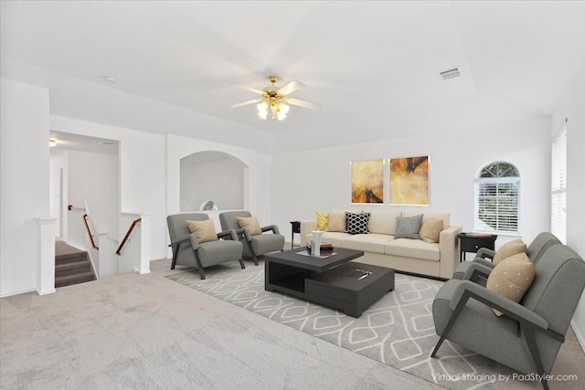 living room with light colored carpet and ceiling fan