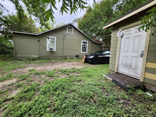 exterior space with a storage shed and cooling unit