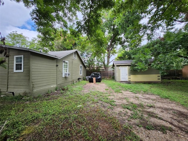 view of yard with a shed and cooling unit