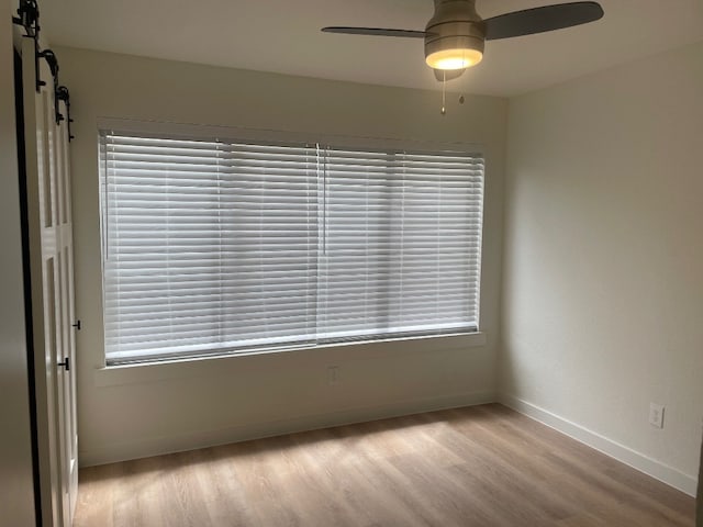 unfurnished room featuring light hardwood / wood-style floors and ceiling fan