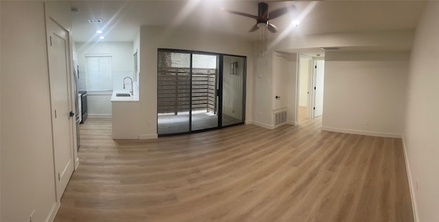 unfurnished room with ceiling fan, hardwood / wood-style flooring, and sink