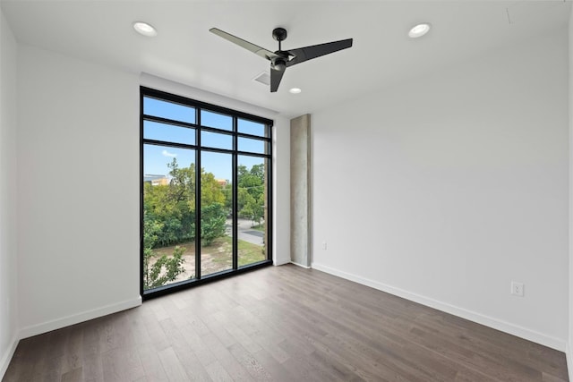 unfurnished room with hardwood / wood-style floors, ceiling fan, and plenty of natural light