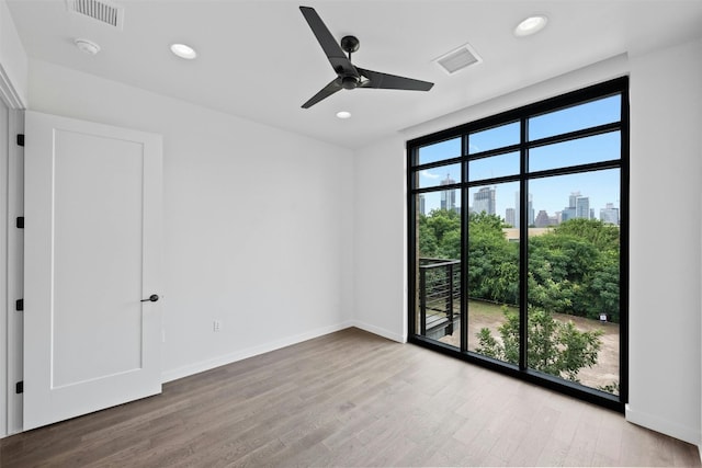 spare room featuring ceiling fan and hardwood / wood-style floors