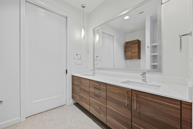 bathroom with dual vanity and tile patterned flooring