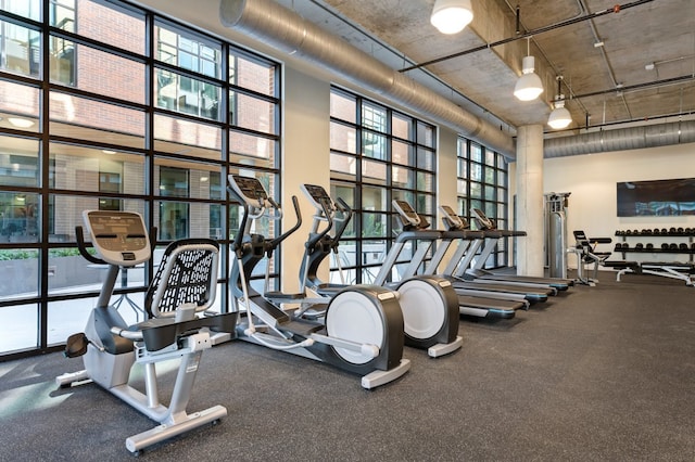 gym with a towering ceiling