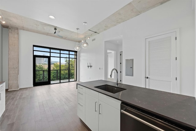 kitchen with white cabinets, sink, pendant lighting, electric panel, and wood-type flooring