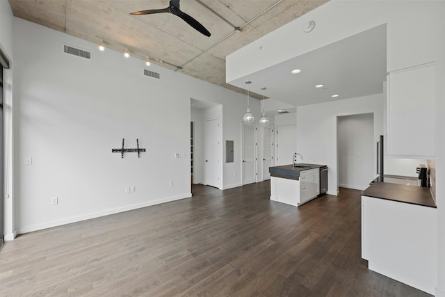 kitchen featuring track lighting, hardwood / wood-style floors, pendant lighting, white cabinetry, and ceiling fan