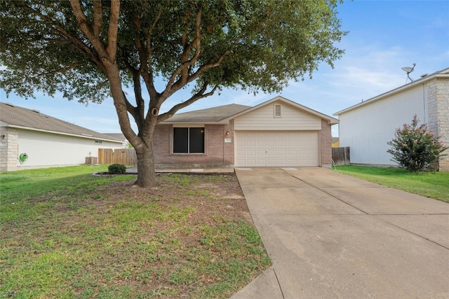 ranch-style home with cooling unit, a garage, and a front yard