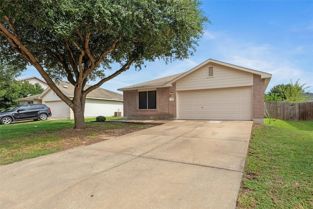 ranch-style home featuring a front lawn and a garage