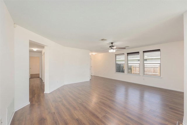 empty room with dark wood-type flooring and ceiling fan