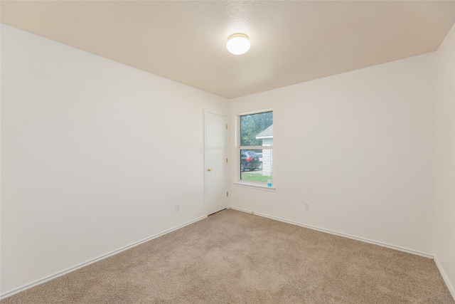 unfurnished room with light colored carpet