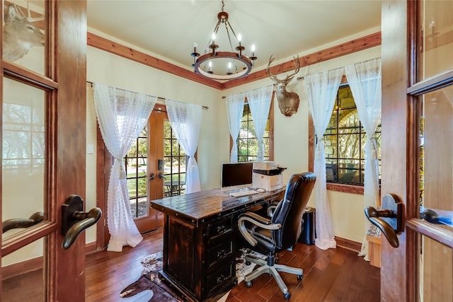 office area with ornamental molding, dark wood-type flooring, an inviting chandelier, and french doors