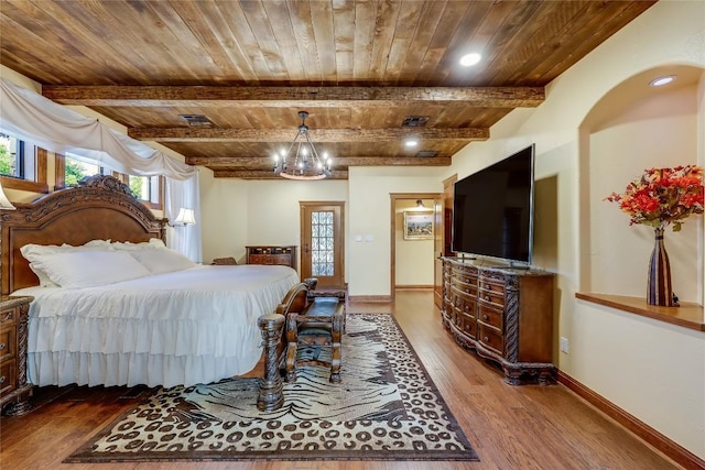 bedroom with beamed ceiling, hardwood / wood-style flooring, a notable chandelier, and wood ceiling