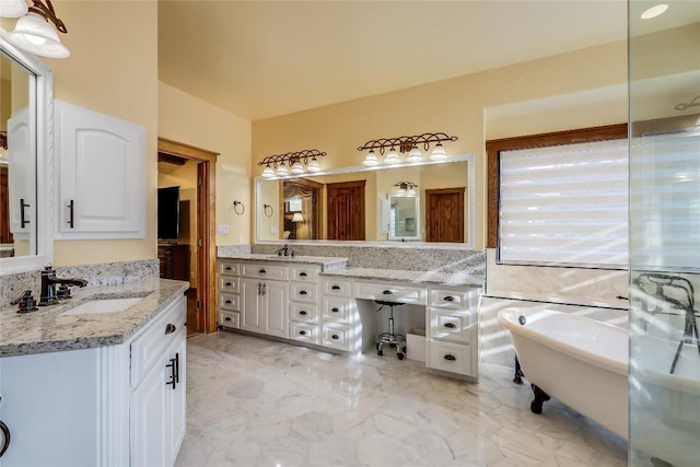 bathroom with vanity and a bath