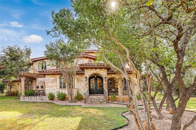 view of front of property with french doors and a front lawn