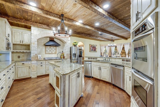 kitchen featuring pendant lighting, sink, light stone counters, stainless steel appliances, and wooden ceiling