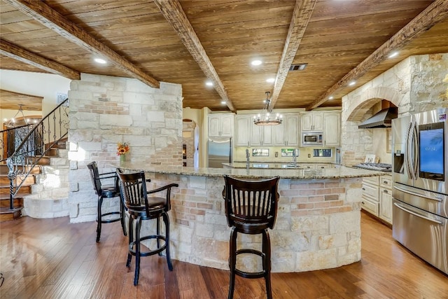 kitchen featuring light stone counters, stainless steel appliances, wooden ceiling, and light wood-type flooring