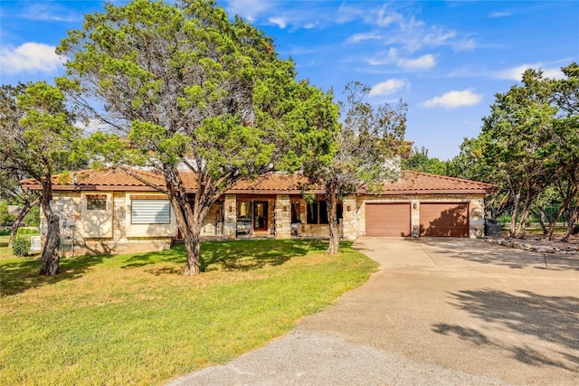 view of front of house with a garage and a front lawn