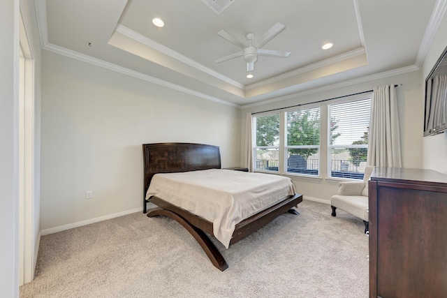 carpeted bedroom with crown molding, ceiling fan, and a tray ceiling