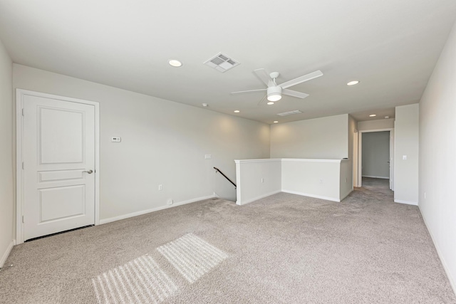 empty room with light colored carpet and ceiling fan