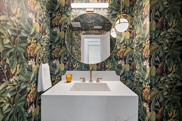 bathroom featuring wallpapered walls and a sink