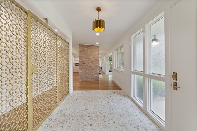 hallway with recessed lighting, decorative columns, and baseboards