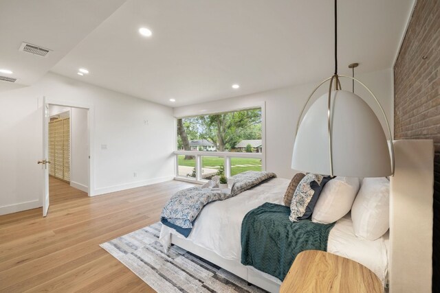 bedroom featuring light wood-style floors, baseboards, visible vents, and recessed lighting