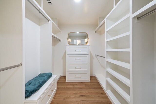 spacious closet featuring light wood-type flooring and visible vents