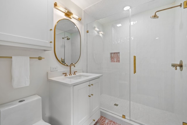 full bathroom with a stall shower, vanity, and toilet