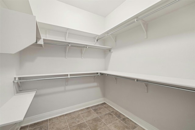 walk in closet featuring tile patterned flooring