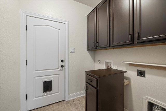 clothes washing area featuring cabinets, light tile patterned floors, electric dryer hookup, and hookup for a washing machine