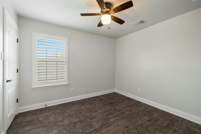 spare room with ceiling fan and dark hardwood / wood-style flooring