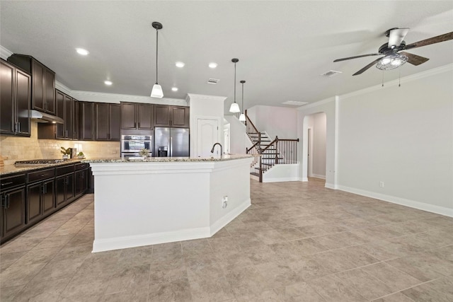 kitchen featuring a kitchen island with sink, pendant lighting, appliances with stainless steel finishes, and ceiling fan