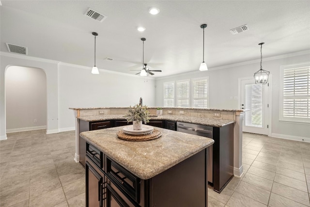 kitchen featuring a kitchen island, ceiling fan with notable chandelier, and light tile patterned floors