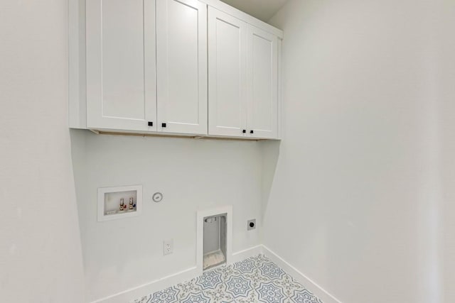 clothes washing area featuring cabinets, hookup for an electric dryer, washer hookup, and hookup for a gas dryer