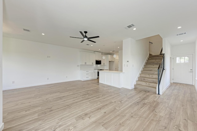 unfurnished living room with ceiling fan and light hardwood / wood-style floors