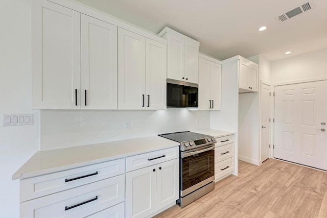 kitchen featuring white cabinetry, stainless steel range with electric cooktop, and light hardwood / wood-style floors