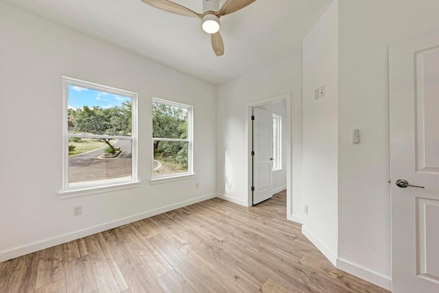 empty room with ceiling fan and light wood-type flooring